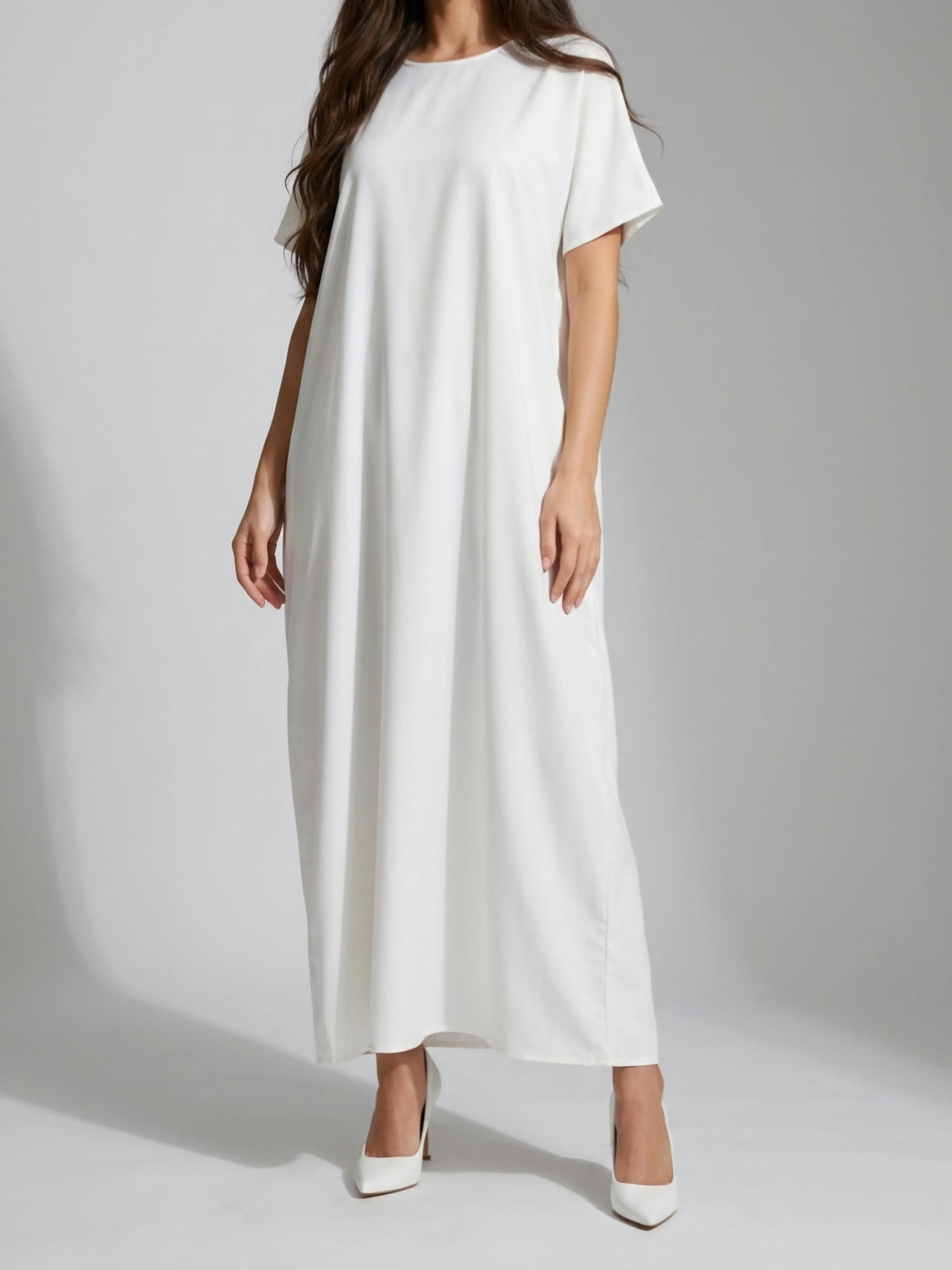 Woman wearing long white innerslip dress