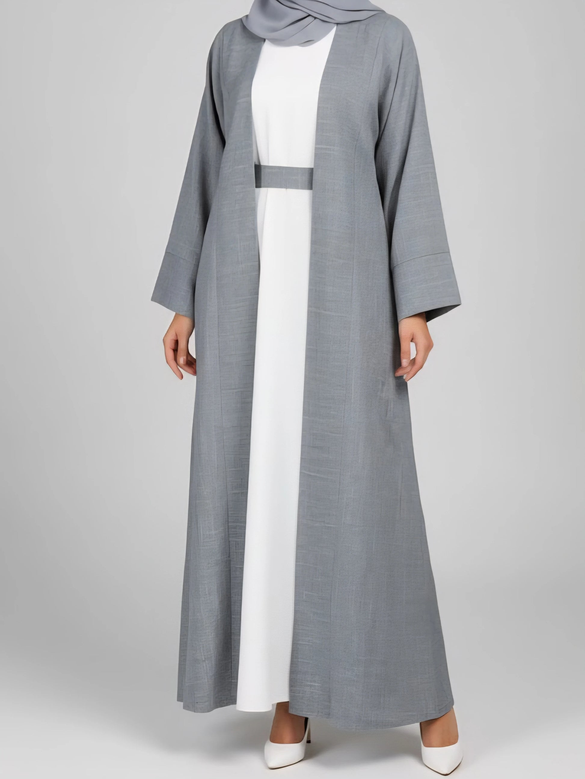 Experience effortless elegance with our grey two-piece abaya set, paired with a crisp white inner slip. Made from a luxurious cotton-linen blend, this Dubai-inspired abaya offers breathable comfort and timeless modest style—perfect for everyday wear or special occasions.
Key Features

Color: Blue abaya with a white inner slip

Fabric: Premium cotton-linen blend

Includes: Abaya, white inner slip, belt, and matching scarf

Style: Two-piece, lightweight, breathable, Dubai luxury design

Ideal For: Everyday we