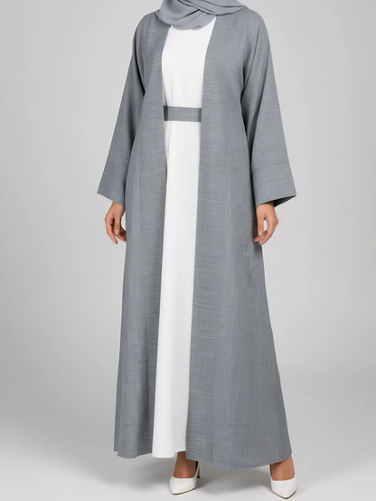 Experience effortless elegance with our grey two-piece abaya set, paired with a crisp white inner slip. Made from a luxurious cotton-linen blend, this Dubai-inspired abaya offers breathable comfort and timeless modest style—perfect for everyday wear or special occasions.
Key Features

Color: Blue abaya with a white inner slip

Fabric: Premium cotton-linen blend

Includes: Abaya, white inner slip, belt, and matching scarf

Style: Two-piece, lightweight, breathable, Dubai luxury design

Ideal For: Everyday we
