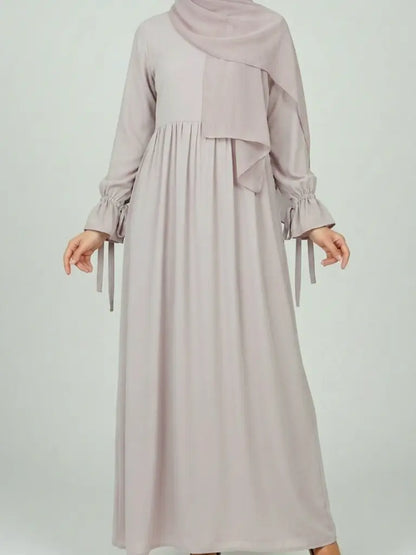 Long ligth beige modest dress with ruffled sleeves and  hijab
