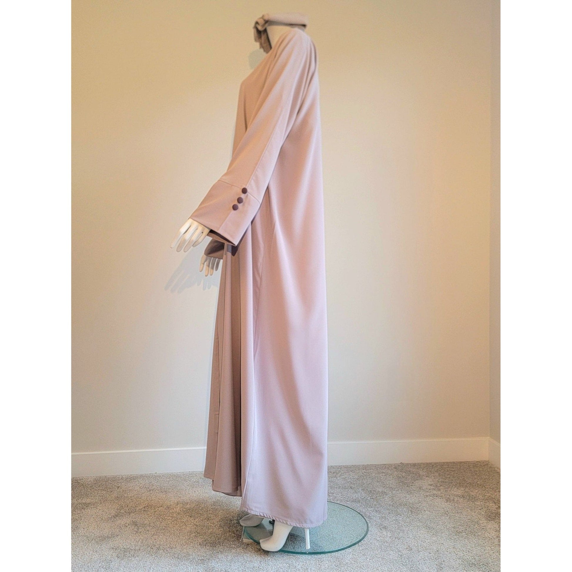 Beige modest Muslim clothing in layered abaya style