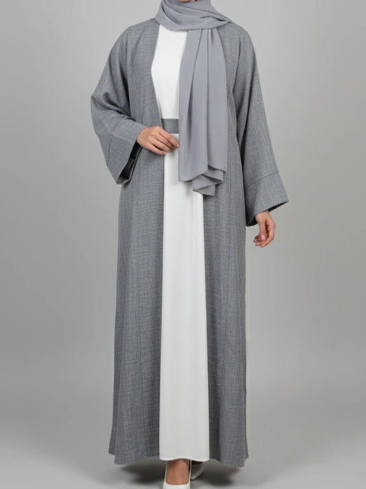 “Luxury grey cotton-linen abaya from Dubai collection with white slip dress – stylish abaya online for Muslim women in Scandinavia.”