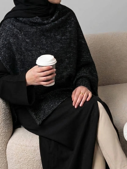 Svart Dubai abaya med elegant lagerdetalj och skimrande finish
